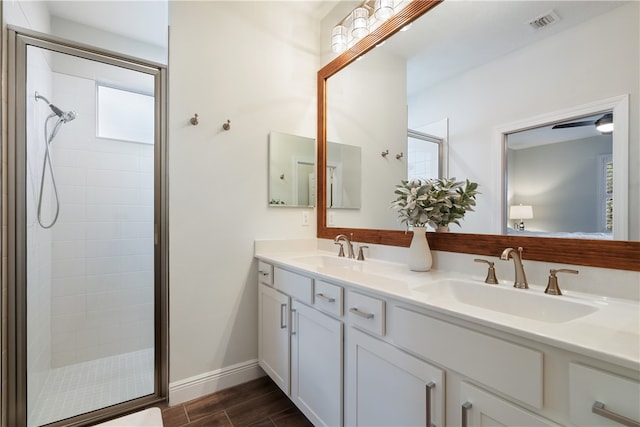 bathroom featuring vanity and a shower with door