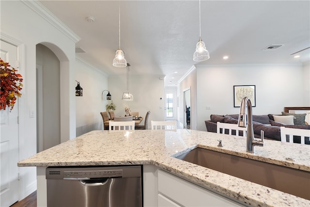 kitchen with stainless steel dishwasher, ornamental molding, sink, pendant lighting, and white cabinetry