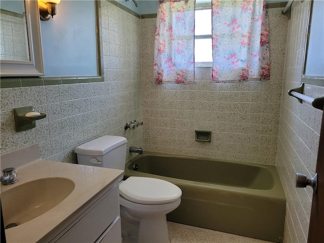 8695 70th Ave, Vero Beach, FL 32967 - bathroom with tile walls, vanity, toilet, and bathing tub / shower combination