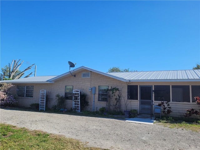 8695 70th Ave, Vero Beach, FL 32967 - view of front of property with metal roof and a sunroom
