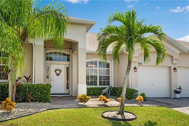 entrance to property with a yard and a garage