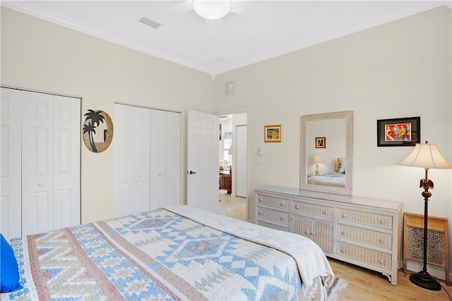 bedroom featuring ceiling fan, crown molding, light hardwood / wood-style flooring, and multiple closets