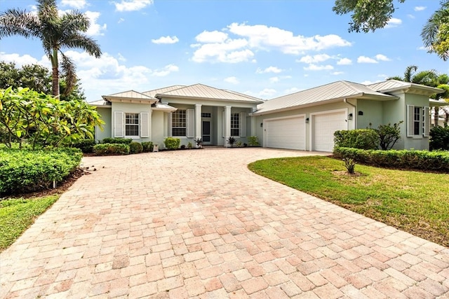 view of front of property with a garage and a front yard