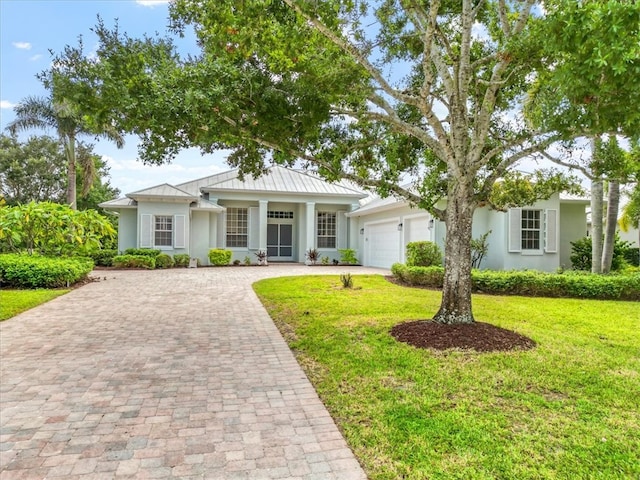 view of front facade with a front yard and a garage