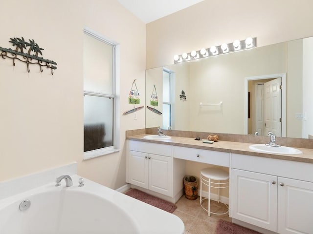 bathroom with tile patterned floors, vanity, and a bathing tub