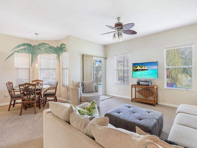 carpeted living room with ceiling fan