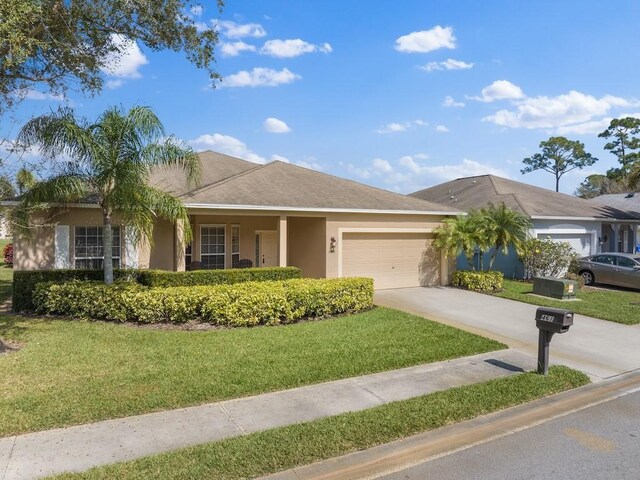 ranch-style home with a garage and a front lawn