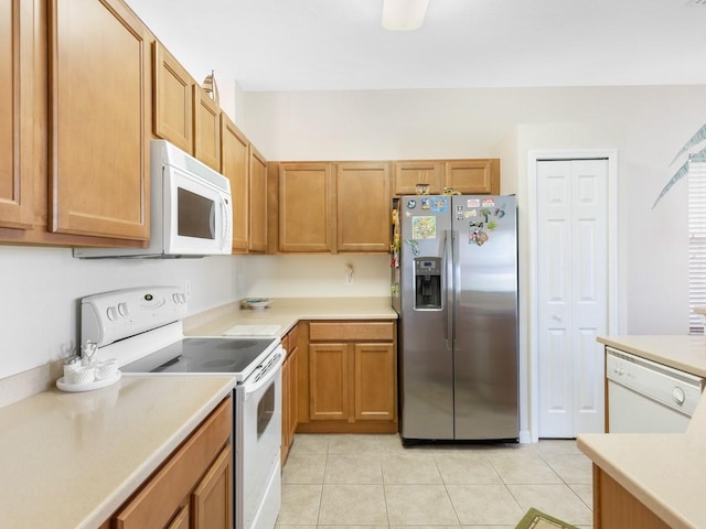 kitchen with white appliances and light tile patterned floors