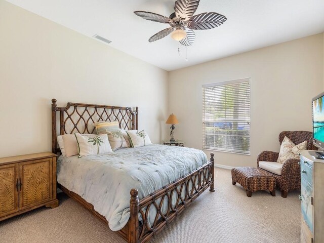 bedroom featuring ceiling fan and carpet