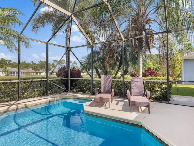 view of pool featuring a patio and glass enclosure