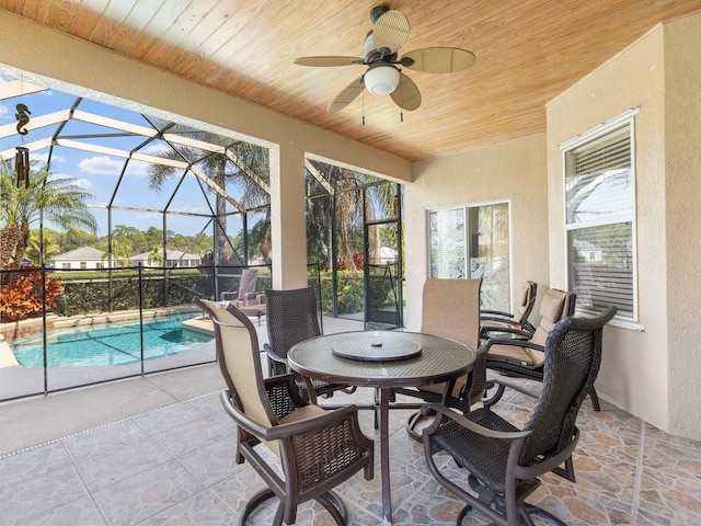 sunroom featuring wood ceiling and ceiling fan