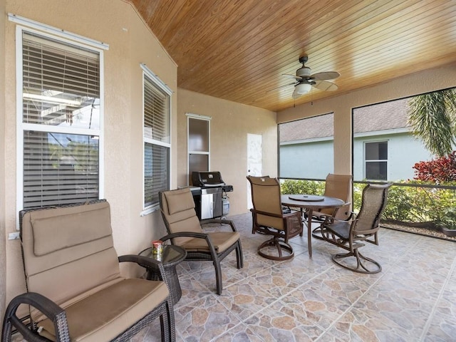 sunroom / solarium with ceiling fan and wood ceiling