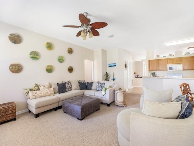 living room with light carpet and ceiling fan