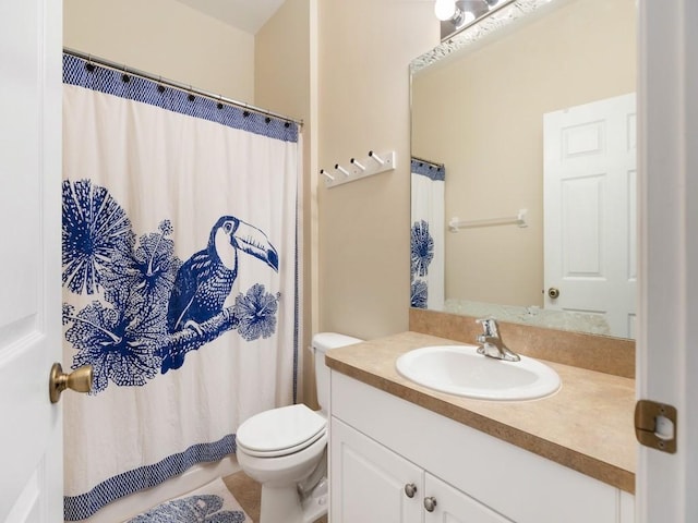 bathroom with vanity, walk in shower, and toilet