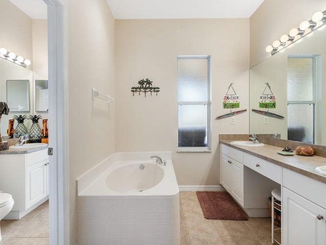 bathroom with vanity, tile patterned floors, and tiled bath