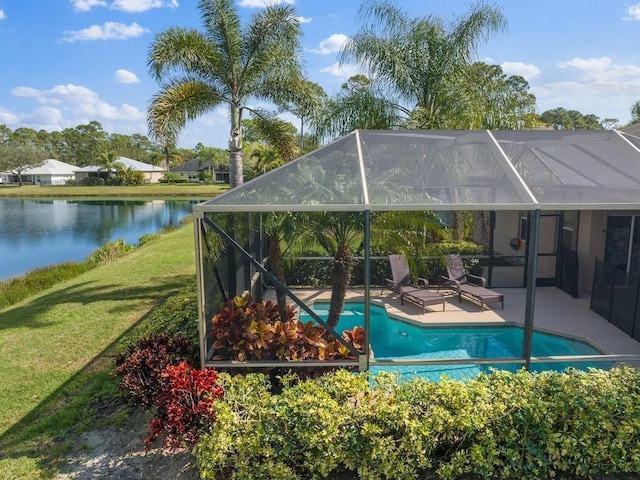 view of pool with a water view, a yard, glass enclosure, and a patio area