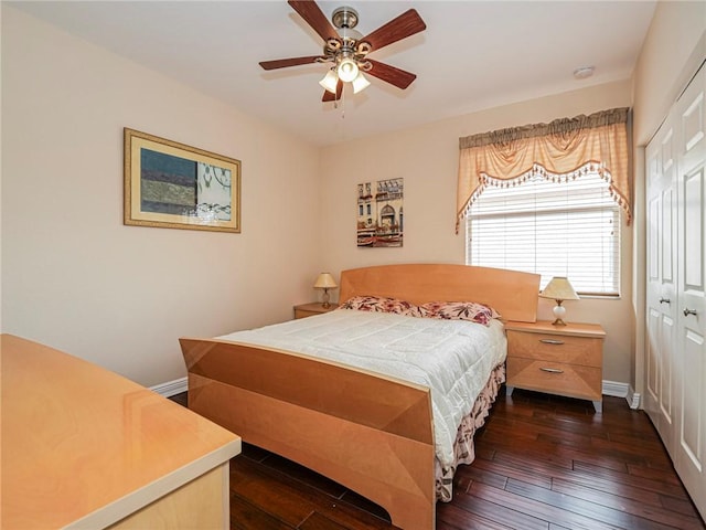 bedroom featuring ceiling fan, dark hardwood / wood-style flooring, and a closet