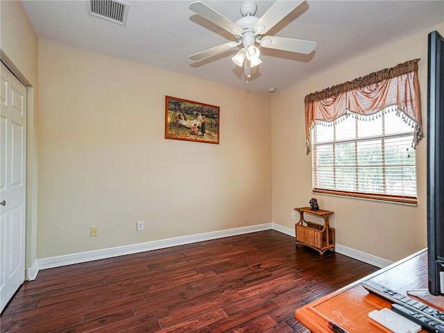 interior space with dark hardwood / wood-style flooring and ceiling fan