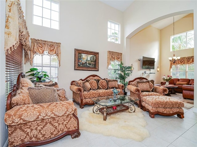 living room with tile patterned flooring, an inviting chandelier, and plenty of natural light