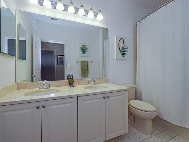 bathroom featuring walk in shower, tile patterned flooring, vanity, and toilet