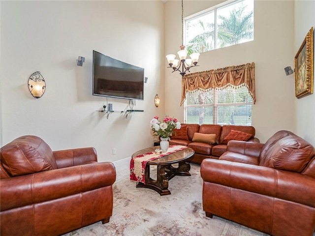 living room with a towering ceiling and an inviting chandelier