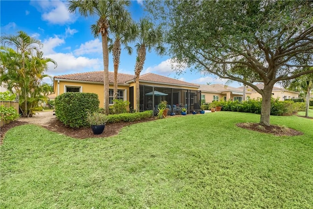 back of house with a sunroom and a lawn