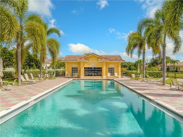 view of swimming pool with an outdoor structure and a patio area