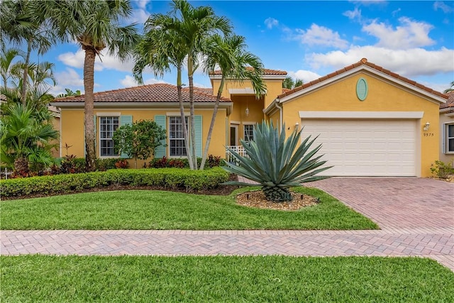 mediterranean / spanish-style house with a garage and a front yard