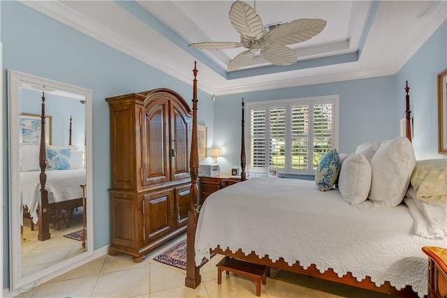 bedroom with crown molding, ceiling fan, a tray ceiling, and light tile patterned floors