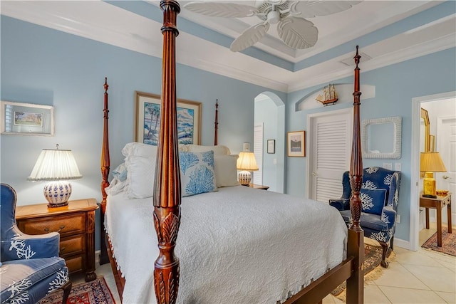 bedroom featuring crown molding, a raised ceiling, ceiling fan, and light tile patterned flooring