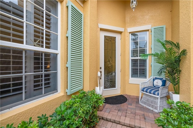 view of exterior entry featuring a patio