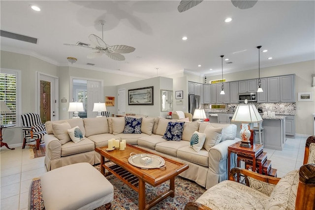 living room with light tile patterned floors, crown molding, and ceiling fan