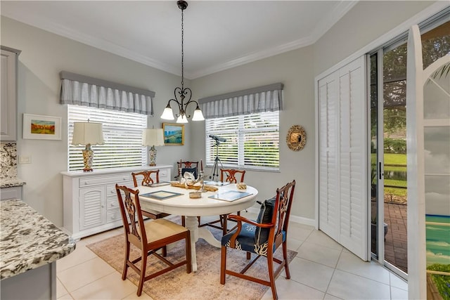 dining area with crown molding, light tile patterned floors, and an inviting chandelier