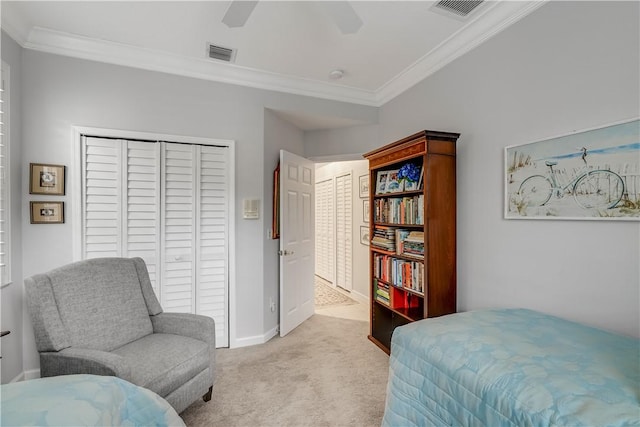 bedroom with light carpet, crown molding, a closet, and ceiling fan