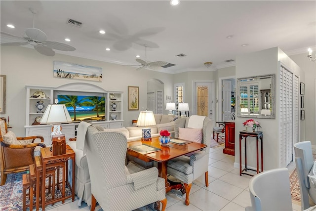 tiled living room with ceiling fan and ornamental molding