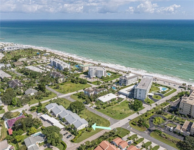 birds eye view of property featuring a beach view and a water view