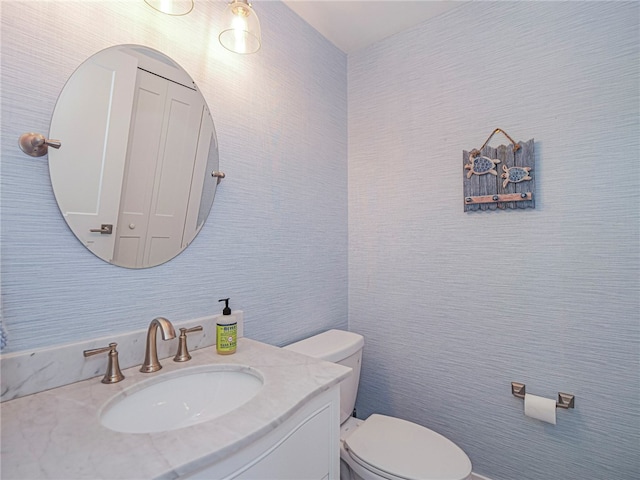 bathroom featuring toilet and vanity