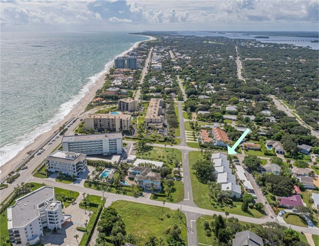 drone / aerial view featuring a view of the beach and a water view