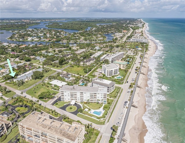 drone / aerial view with a beach view and a water view