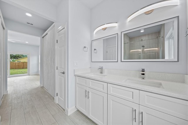 7160 Carlowe Ave, Cocoa, FL 32927 - bathroom with double vanity, a tile shower, and recessed lighting