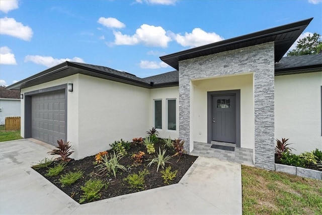 7160 Carlowe Ave, Cocoa, FL 32927 - property entrance featuring an attached garage, stucco siding, driveway, and stone siding