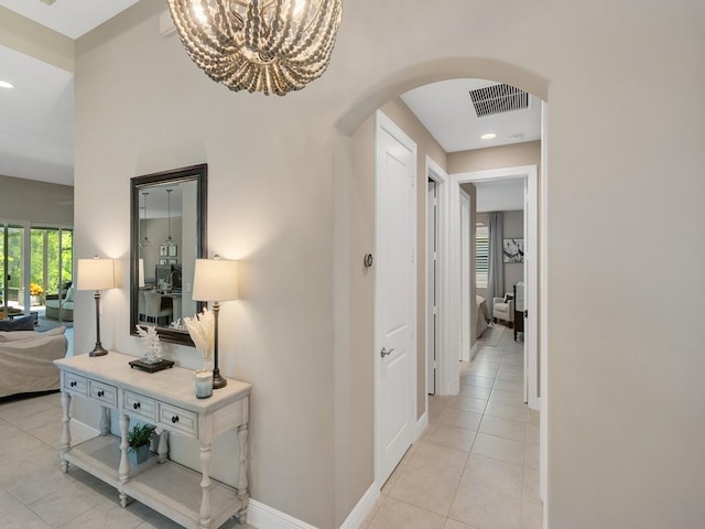 7257 33rd Sq, Vero Beach, FL 32967 - corridor featuring arched walkways, visible vents, an inviting chandelier, recessed lighting, and light tile patterned floors