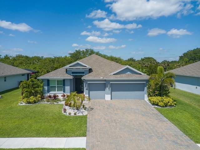 7257 33rd Sq, Vero Beach, FL 32967 - single story home featuring a shingled roof, an attached garage, stucco siding, a front lawn, and decorative driveway