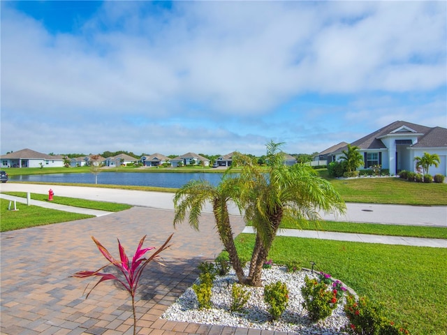 exterior space with a water view and a lawn