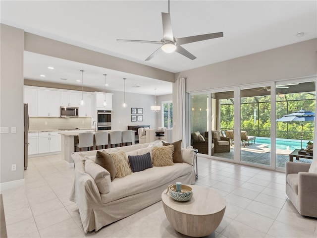 living room featuring ceiling fan and light tile patterned floors