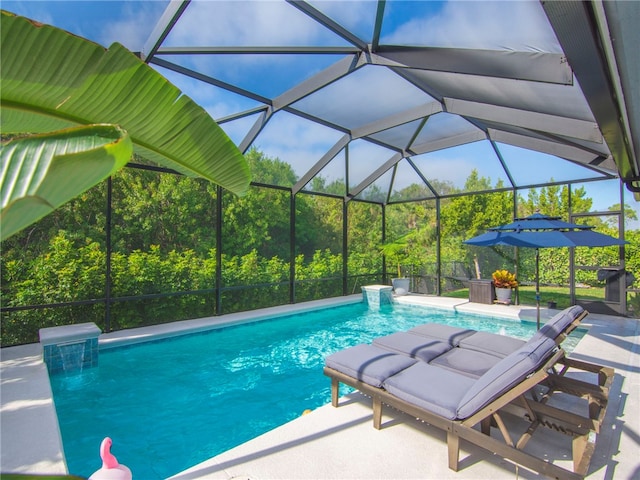 view of pool featuring pool water feature, glass enclosure, and a patio area