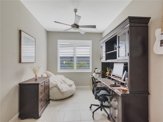 tiled home office featuring ceiling fan