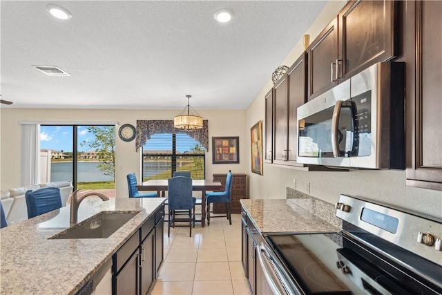 10008 W Villa Cir Unit 10008, Vero Beach, FL 32966 - kitchen featuring dark brown cabinetry, visible vents, decorative light fixtures, appliances with stainless steel finishes, and a sink