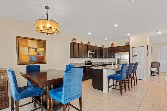 10008 W Villa Cir Unit 10008, Vero Beach, FL 32966 - dining space featuring light tile patterned floors, an inviting chandelier, and recessed lighting