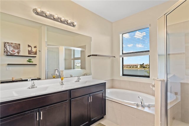 10008 W Villa Cir Unit 10008, Vero Beach, FL 32966 - full bathroom featuring a garden tub, a sink, double vanity, and a shower stall